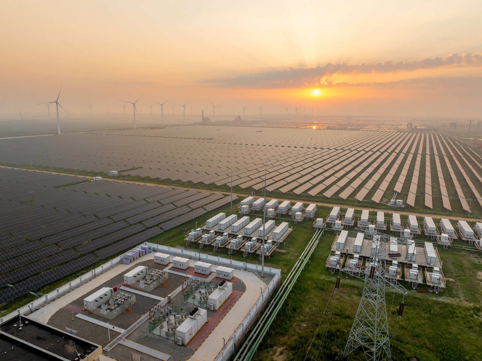 Energy storage power station, solar power station and wind power station at sunrise